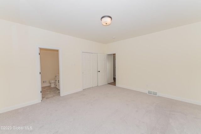 unfurnished room with light carpet, baseboards, and visible vents