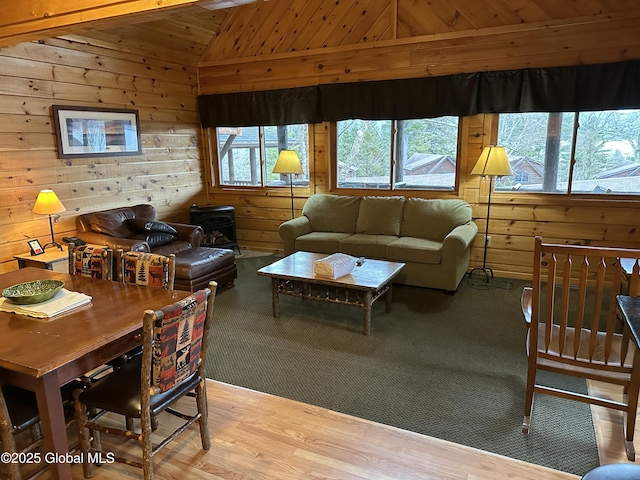 3210 Lake Shore Dr Unit 24Interval 2, Lake George, NY 12845 - living room with wooden walls, a wood stove, vaulted ceiling, and light wood-style flooring