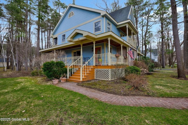 view of front facade featuring a front lawn and covered porch