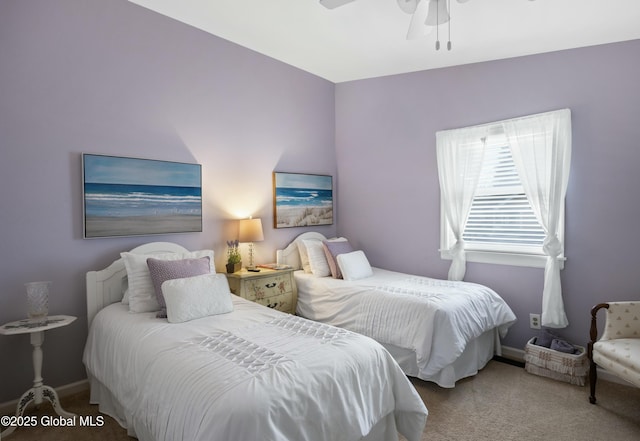 bedroom with a ceiling fan, baseboards, and carpet