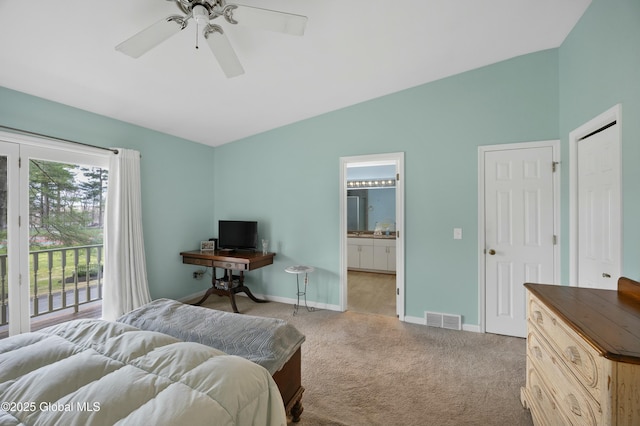 carpeted bedroom with vaulted ceiling, ensuite bathroom, baseboards, access to outside, and visible vents