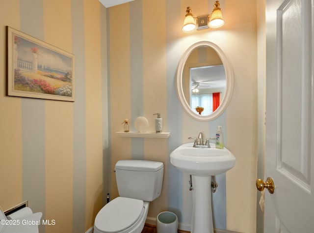 bathroom featuring a ceiling fan, a sink, and toilet