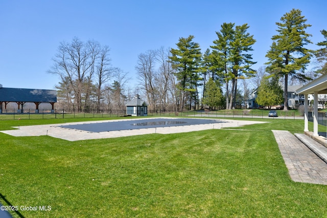 exterior space featuring fence, an outdoor structure, and a yard