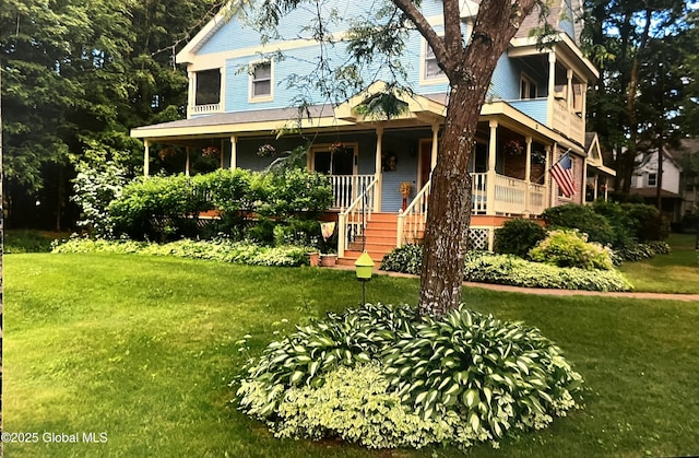 view of front of home with a porch and a front lawn