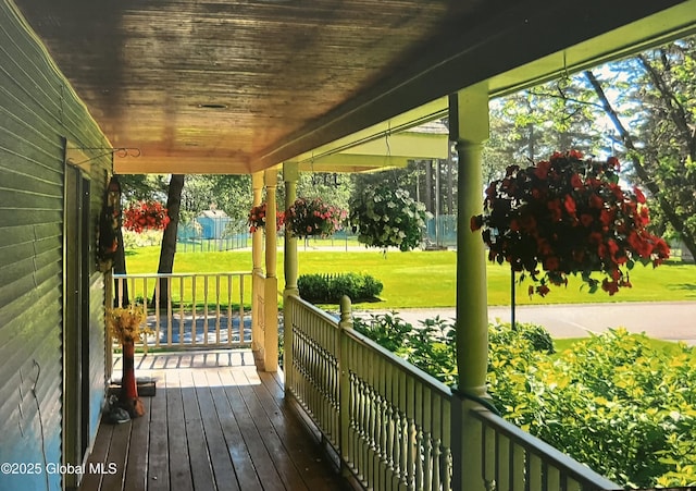 deck featuring a yard and a porch