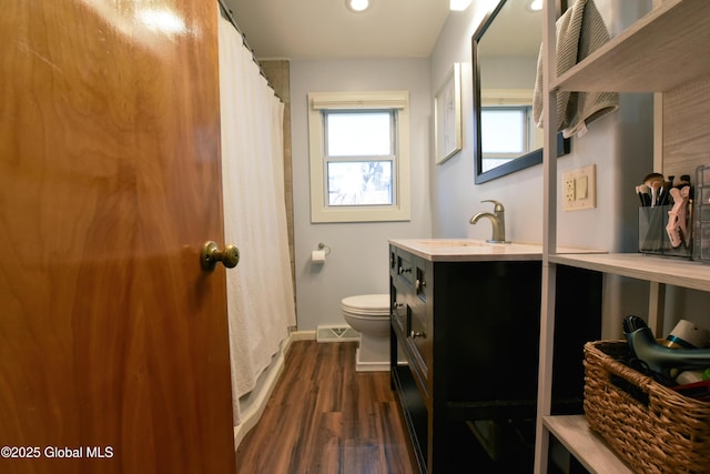 full bathroom featuring vanity, toilet, recessed lighting, baseboards, and wood finished floors