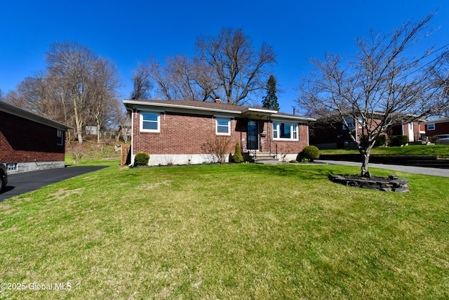single story home featuring a front yard and brick siding
