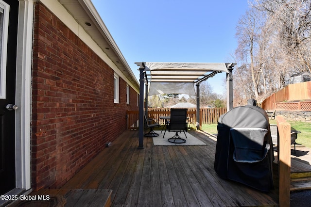 deck featuring a fenced backyard, a pergola, and outdoor dining area