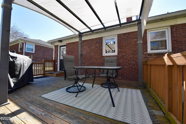 wooden deck featuring fence and outdoor dining space