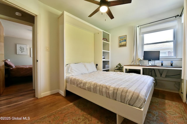 bedroom with baseboards and wood finished floors