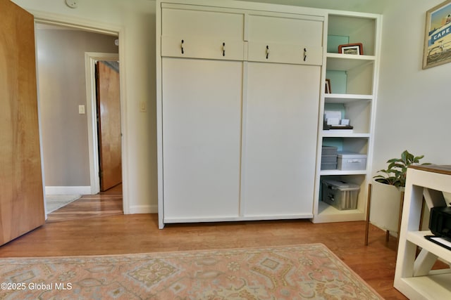 unfurnished bedroom with baseboards and wood finished floors