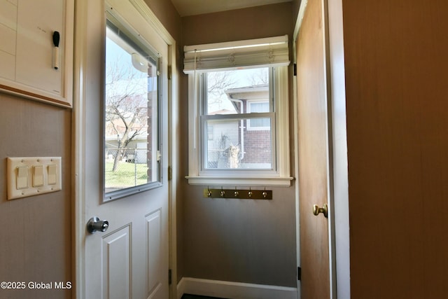 doorway featuring a healthy amount of sunlight and baseboards