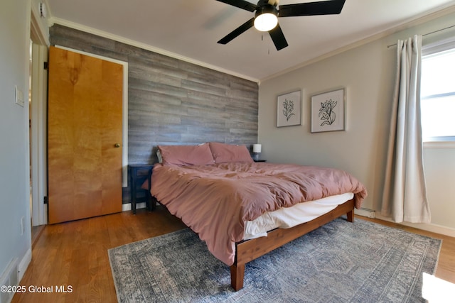 bedroom featuring ornamental molding, ceiling fan, and wood finished floors