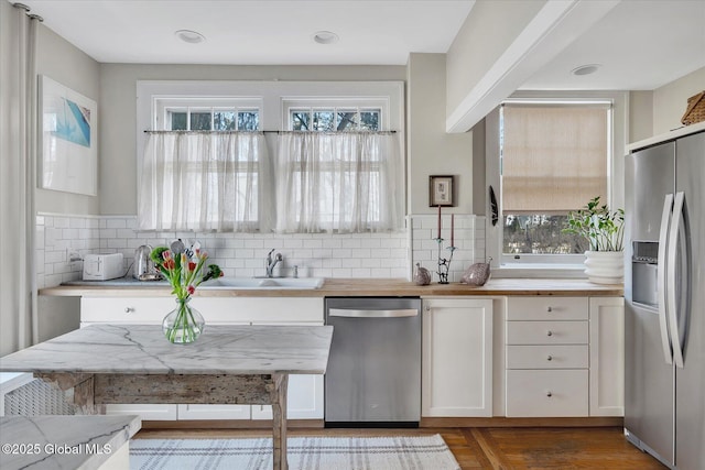 39 5th Ave, Saratoga Springs, NY 12866 - kitchen with appliances with stainless steel finishes, white cabinets, decorative backsplash, and butcher block countertops