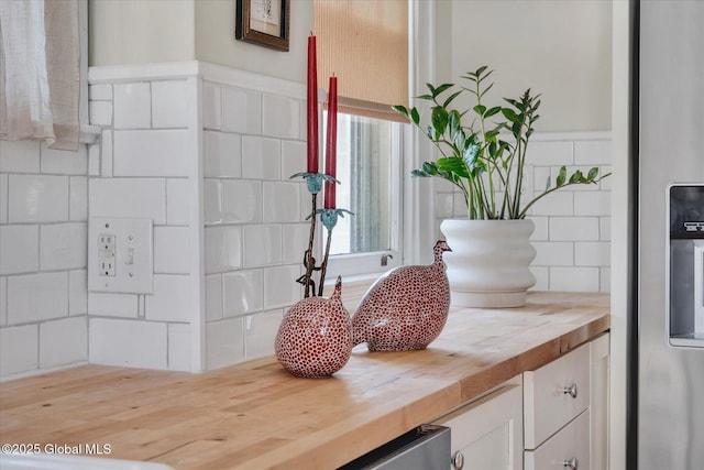 39 5th Ave, Saratoga Springs, NY 12866 - kitchen view of wooden counters, white cabinets, stainless steel refrigerator with ice dispenser, and backsplash
