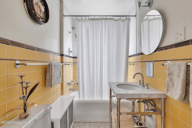 39 5th Ave, Saratoga Springs, NY 12866 - bathroom featuring tile walls, shower / bath combo with shower curtain, wainscoting, and tile patterned floors