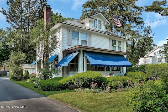 39 5th Ave, Saratoga Springs, NY 12866 - traditional style home featuring a chimney and a front yard