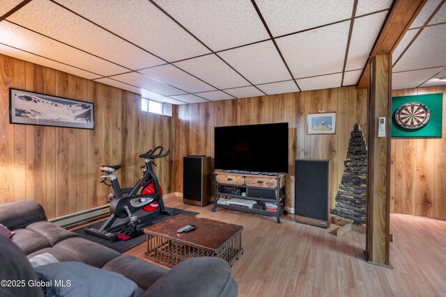 92 Vosburgh Rd, Halfmoon, NY 12118 - living area with baseboard heating, wood walls, wood finished floors, a drop ceiling, and baseboards