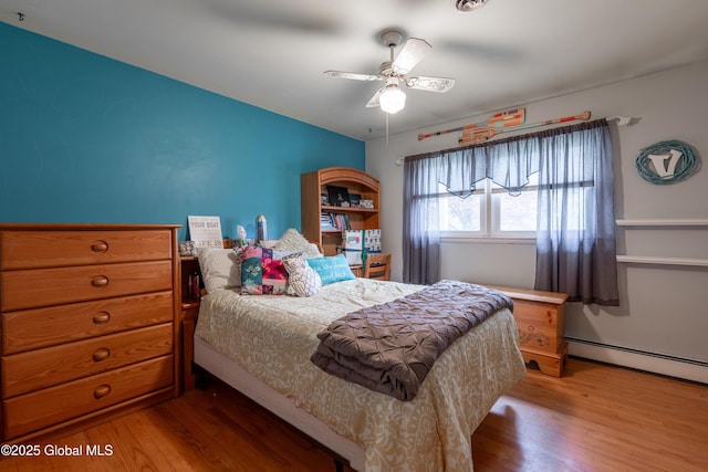 92 Vosburgh Rd, Halfmoon, NY 12118 - bedroom with wood finished floors, baseboard heating, and a ceiling fan