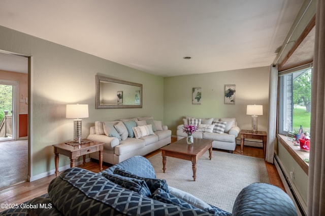92 Vosburgh Rd, Halfmoon, NY 12118 - living area featuring a baseboard radiator, wood finished floors, plenty of natural light, and baseboard heating