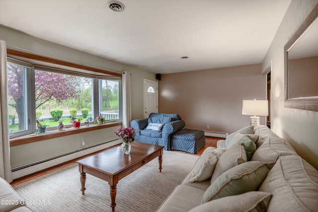 92 Vosburgh Rd, Halfmoon, NY 12118 - living area with a baseboard heating unit, healthy amount of natural light, a baseboard radiator, and wood finished floors