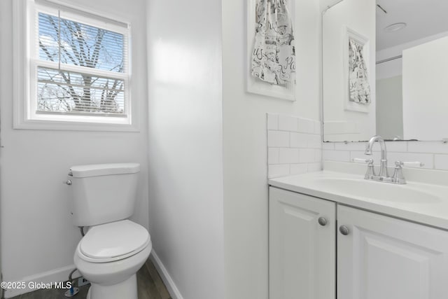 7 Arch Ave, Bethlehem, NY 12203 - bathroom featuring toilet, decorative backsplash, baseboards, and vanity