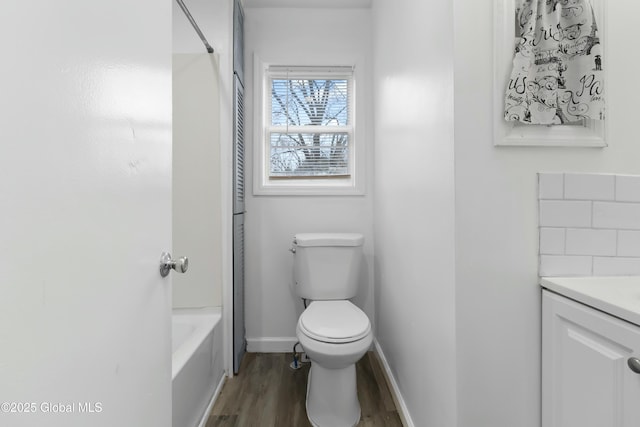 7 Arch Ave, Bethlehem, NY 12203 - bathroom with washtub / shower combination, toilet, vanity, wood finished floors, and decorative backsplash
