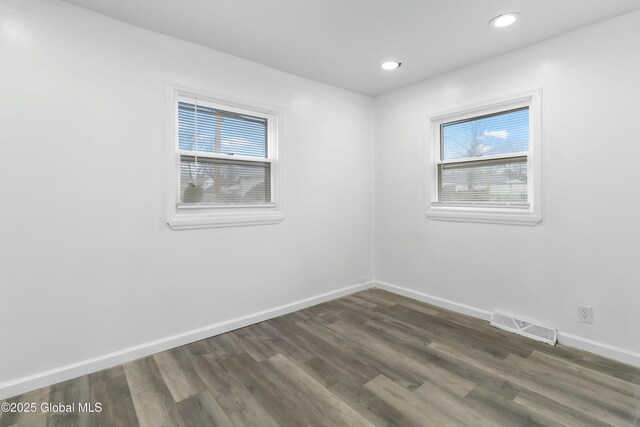 7 Arch Ave, Bethlehem, NY 12203 - unfurnished room with dark wood-style flooring, visible vents, baseboards, and a healthy amount of sunlight