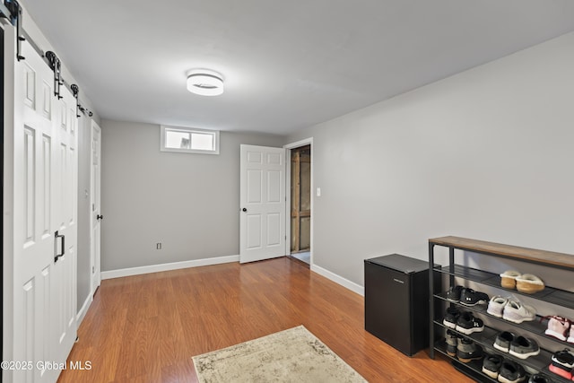 419 Brownell Rd, Malta, NY 12020 - office area with a barn door, baseboards, and wood finished floors