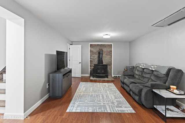 419 Brownell Rd, Malta, NY 12020 - living room with a wood stove, baseboards, and wood finished floors
