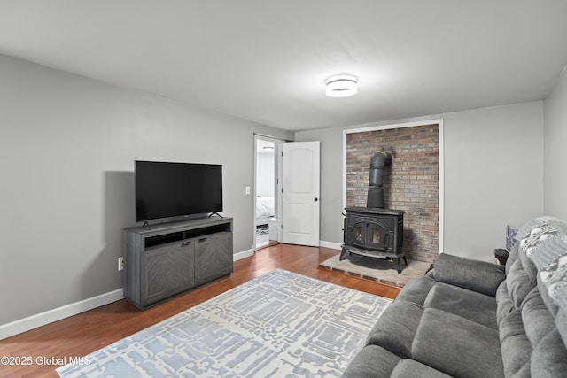 419 Brownell Rd, Malta, NY 12020 - living area featuring wood finished floors, a wood stove, and baseboards