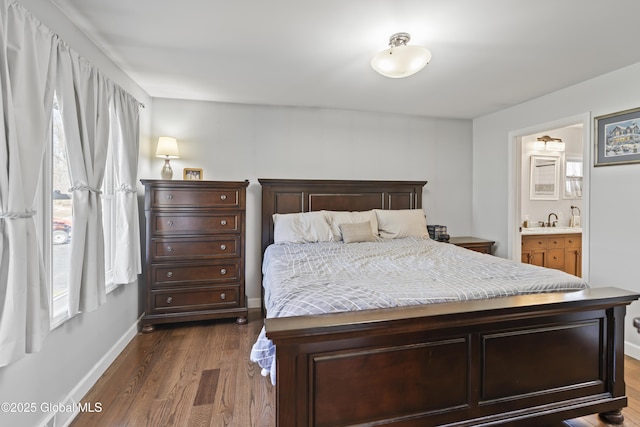 419 Brownell Rd, Malta, NY 12020 - bedroom featuring dark wood-type flooring, ensuite bathroom, baseboards, and a sink