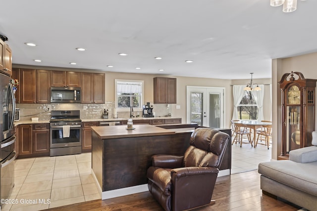 419 Brownell Rd, Malta, NY 12020 - kitchen featuring open floor plan, appliances with stainless steel finishes, light countertops, and backsplash