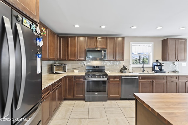 419 Brownell Rd, Malta, NY 12020 - kitchen featuring a sink, appliances with stainless steel finishes, recessed lighting, butcher block countertops, and decorative backsplash