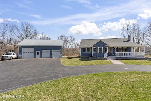 419 Brownell Rd, Malta, NY 12020 - view of front of house with an outbuilding, a porch, a front yard, a chimney, and a garage