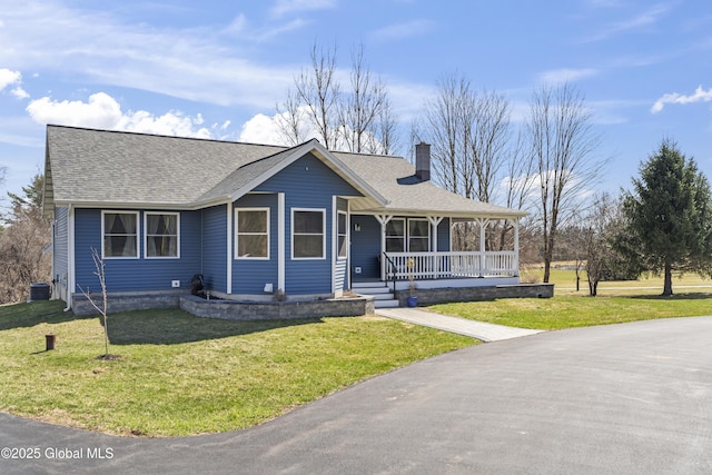 419 Brownell Rd, Malta, NY 12020 - view of front facade with roof with shingles, a chimney, cooling unit, a front yard, and a porch
