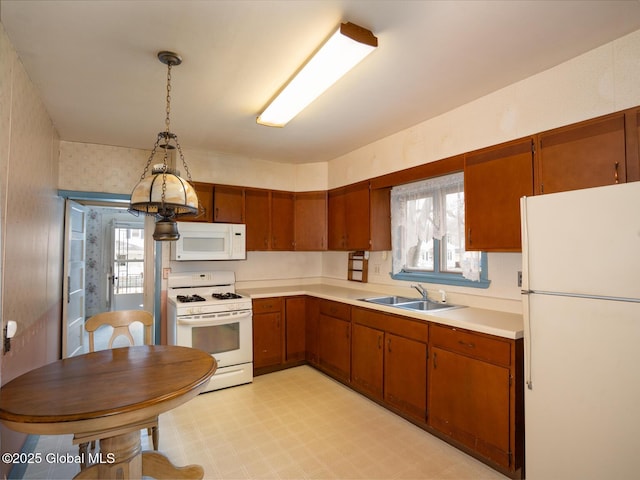 16 Oakwood Blvd, Hudson, NY 12534 - kitchen with white appliances, light floors, light countertops, and brown cabinets