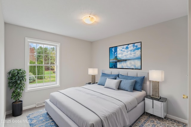 carpeted bedroom featuring baseboards