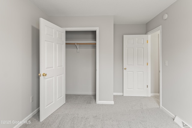 unfurnished bedroom with carpet flooring, baseboards, and visible vents