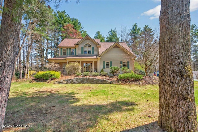 traditional-style home with a porch and a front lawn