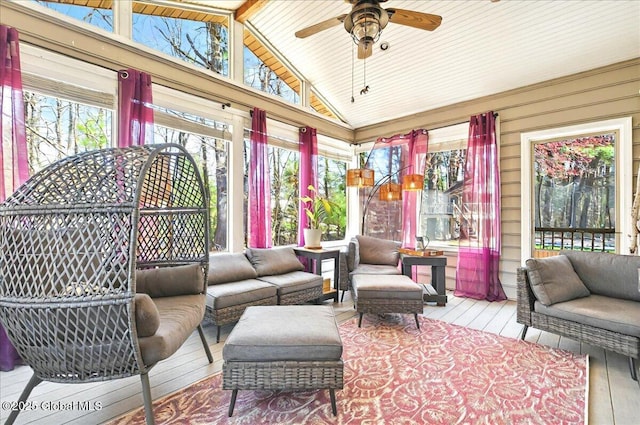 sunroom / solarium with wood-type flooring, wooden walls, high vaulted ceiling, and wooden ceiling