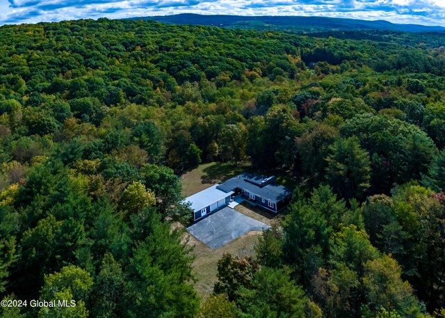 birds eye view of property featuring a view of trees