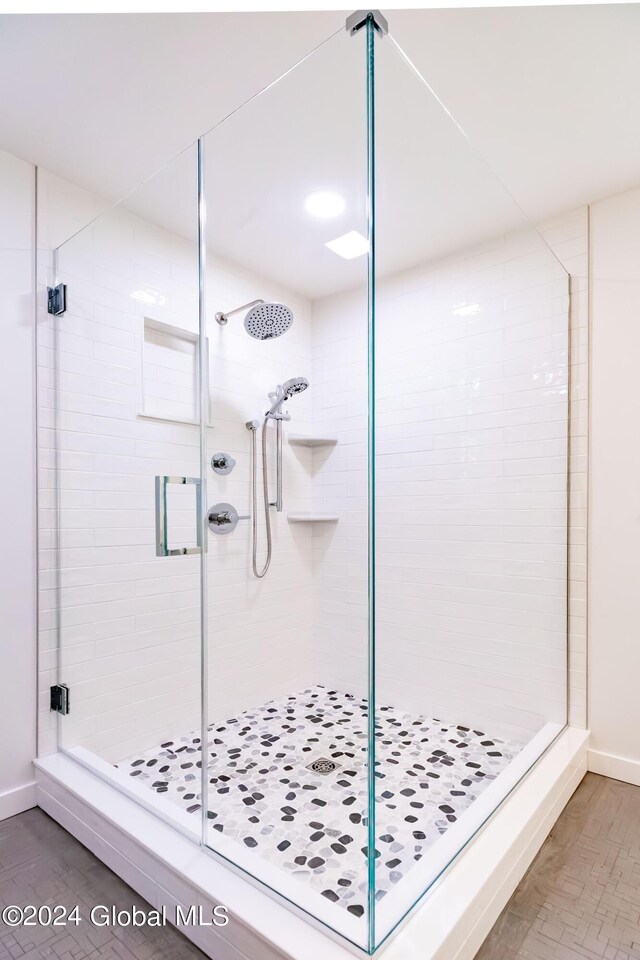 bathroom with baseboards and a stall shower