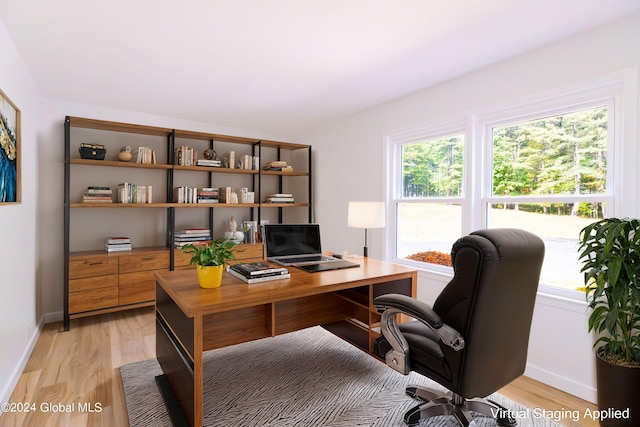 home office with light wood finished floors and baseboards