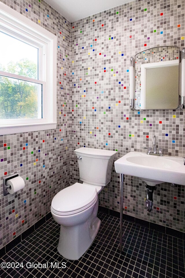 bathroom featuring tile walls, toilet, and tile patterned flooring