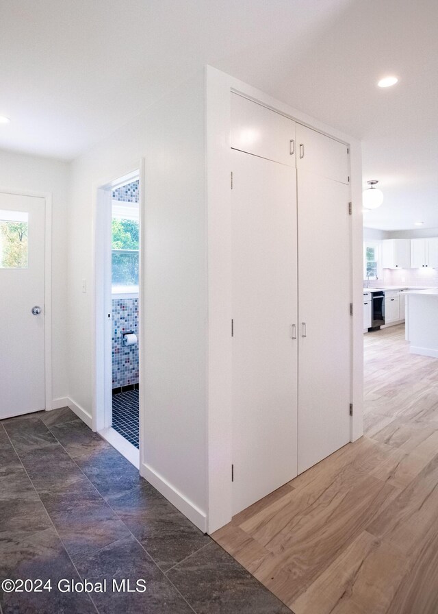 hallway with baseboards and recessed lighting