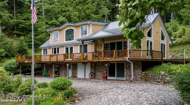 1141 N Shore Rd, Day, NY 12835 - rear view of property featuring a wooden deck, a patio area, a forest view, and stone siding