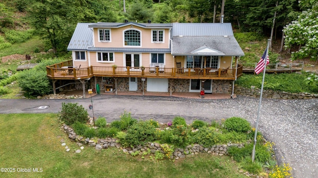 1141 N Shore Rd, Day, NY 12835 - back of property featuring a deck, asphalt driveway, a patio, and stone siding