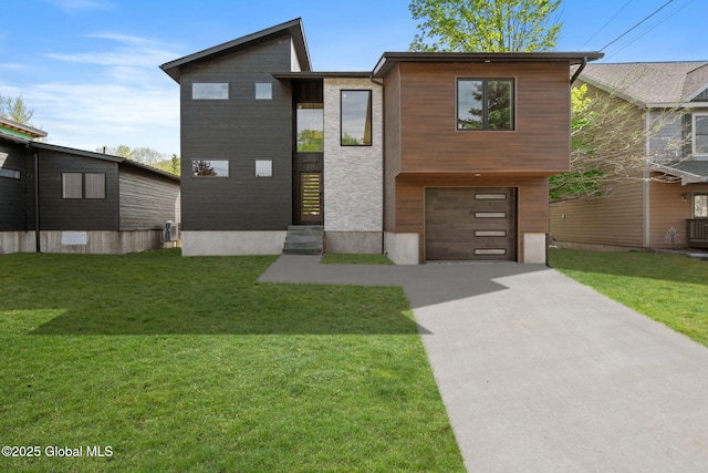 modern home featuring driveway, a garage, a front lawn, and central AC