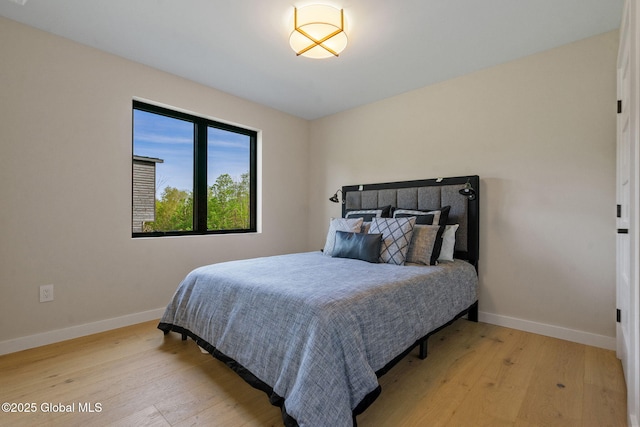 bedroom featuring wood finished floors and baseboards
